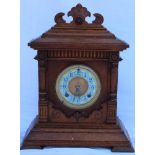A LATE 19TH / EARLY 20TH CENTURY OAK CASED ARCHITECTURAL DESIGN MANTEL CLOCK, by Ansonia of New