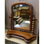 A 19TH CENTURY MAHOGANY ARCHED TOPPED ADJUSTABLE DRESSING TABLE TOP MIRROR on turned uprights &