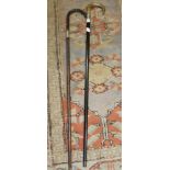 TWO HOOKED WALKING STICKS, with silver collar mounts, one having horn handle