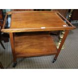 A RETRO TEAK FINISHED TWO-TIER TEA TROLLEY the upper section lifting out as a shallow tray