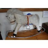 A 1970'S MERRYTHOUGHT BRANDED ROCKING WHITE PONY with remains of original saddle on a chromed