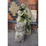 A CAST CONCRETE FIGURE OF A COURTING COUPLE together with a stylised cast owl