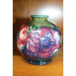 A MOORCROFT CERAMIC VASE of globular form, tube lined and hand painted anemone decoration, impressed