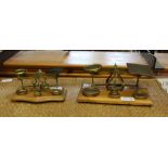 TWO SETS OF BRASS POSTAL SCALES with weights on wooden plinth bases
