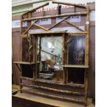 A BAMBOO OVERMANTEL with central mirror plate, twin lacquered panels & trio of display shelves,