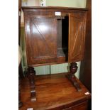 A SCRATCH TWO DOOR SIDE CABINET supported on large baluster uprights & sleigh feet