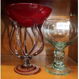 AN OVERSIZED BLOWN GLASS GOBLET, together with a red bowled modernist table centrepiece