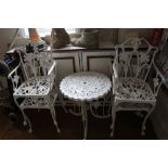 A WHITE PAINTED CAST METAL PATIO SUITE, comprising small circular topped table, and four chairs, two