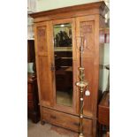 AN ART NOUVEAU DESIGN OAK WARDROBE having single insert bevelled mirror door over full width shoe