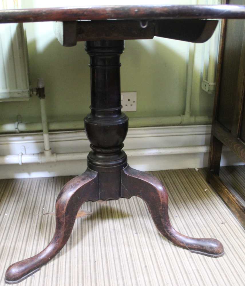 A 19TH CENTURY MAHOGANY CIRCULAR TILT TOP TABLE on turned column and three outswept legs - Image 2 of 2