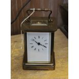 A 20TH CENTURY BRASS CASED CARRIAGE CLOCK, white enamel dial with Roman numerals, 8-day movement