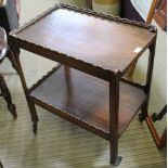 AN OAK FINISHED TWO TIER SERVING TROLLEY