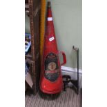 A RED PAINTED TRUMPET SHAPED MINI MAX FIRE EXTINGUISHER complete with wall mounting bracket