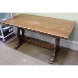 A REPRODUCTION OAK FINISHED RECTANGULAR TRESTLE TYPE TABLE on pierced shaped plank supports