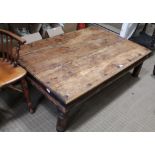 AN IMPORTED HARDWOOD PLANK TOPPED COFFEE TABLE on short turned legs with decorative metalwork