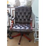 A REPRODUCTION FAUX LEATHER BUTTONED EXECUTIVES DESK CHAIR