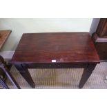 A MAHOGANY COLOURED PROBABLE IMPORTED HARD WOOD SIDE TABLE fitted with a single central drawer, with
