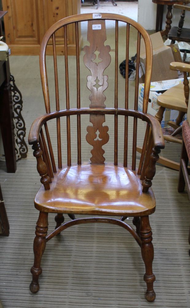 A LATE 19TH / EARLY 20TH CENTURY DOUBLE COMB BACKED ARMCHAIR with solid seat, supported four splayed