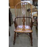 A LATE 19TH / EARLY 20TH CENTURY DOUBLE COMB BACKED ARMCHAIR with solid seat, supported four splayed