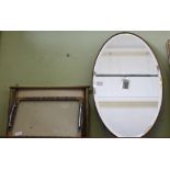 AN OVAL BEVEL PLATE WALL MIRROR, together with two useful trays