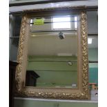 A LARGE RECTANGULAR BEVEL PLATE WALL MIRROR in fancy gilt frame, with leaf and berry pattern