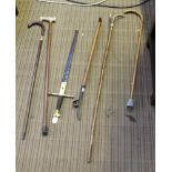 A SELECTION OF WALKING STICKS and associated items, to include a weed dibber