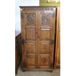 A GOOD QUALITY REPRODUCTION OAK TWO DOOR HALL CUPBOARD