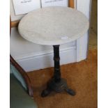 A WHITE GRANITE CIRCULAR TOPPED TABLE on black painted cast metal base