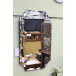 A 1930'S UNFRAMED SCALLOP BEVELLED EDGE WALL MIRROR
