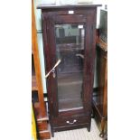 A MAHOGANY FINISHED IMPORTED HARDWOOD GLASS FRONTED SET OF SHELVES with single door, over a single