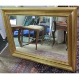 A LARGE PLAIN RECTANGULAR PLATE MIRROR, in fancy gilt frame