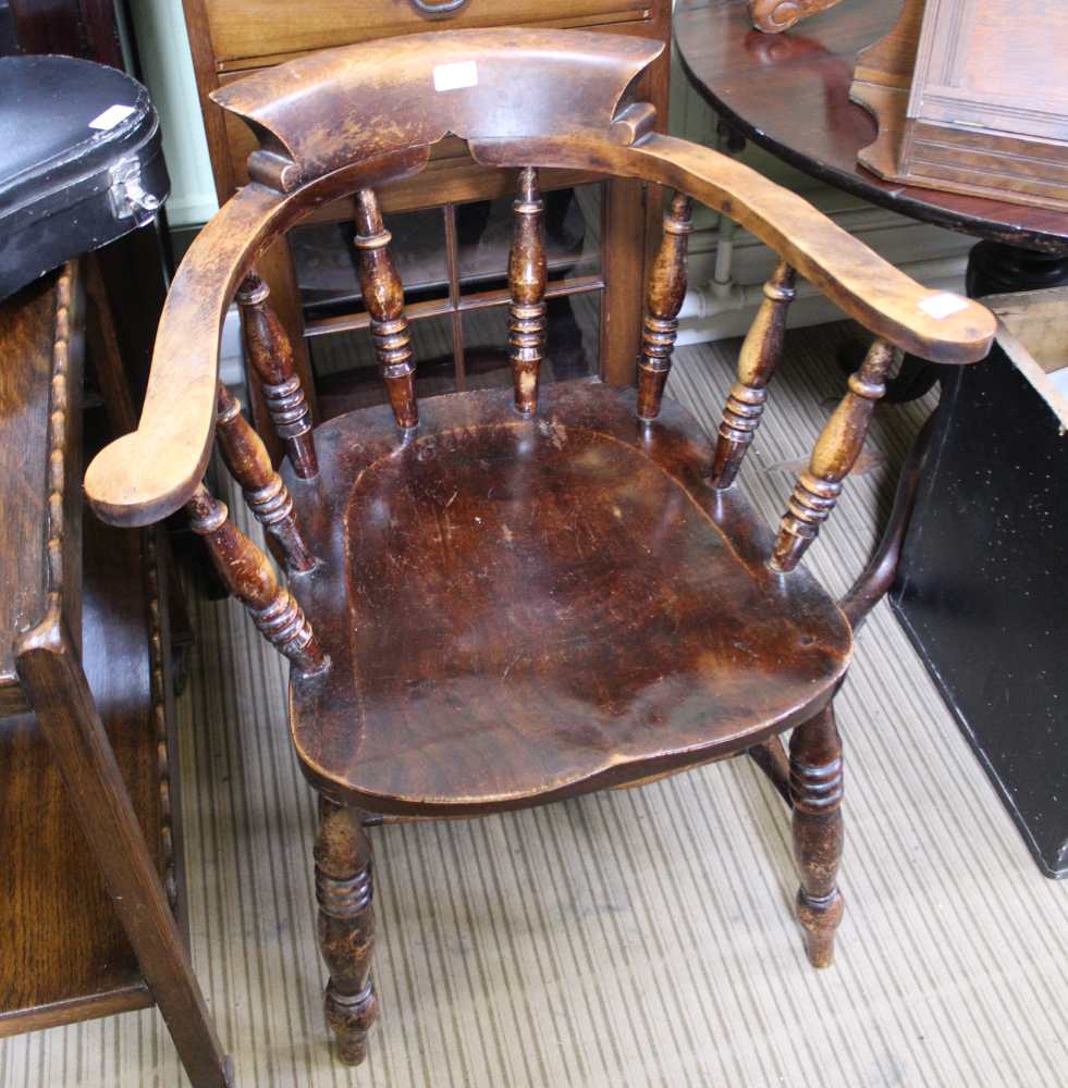 A 20TH CENTURY CAPTAIN'S ARMCHAIR with horseshoe back on a solid seat