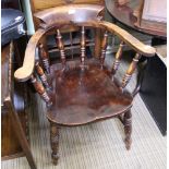 A 20TH CENTURY CAPTAIN'S ARMCHAIR with horseshoe back on a solid seat