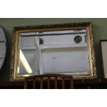 A FANCY GILT FRAMED RECTANGULAR BEVEL PLATE WALL MIRROR