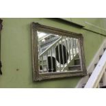 A LARGE RECTANGULAR BEVELLED PLATED WALL MIRROR in fancy modern moulded frame