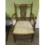 AN EDWARDIAN FANCY BACKED ARMCHAIR with shallow seat pad