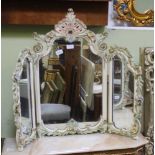 A DECORATIVELY PAINTED FLORAL FRAMED FOLDING TRIPLE PLATE DRESSING TABLE MIRROR