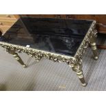 A RECTANGULAR SMOKED GLASS TOPPED COFFEE TABLE on fancy pierced and gilded four legged frame