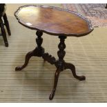 A REPRODUCTION PIECRUST EDGED OVAL COFFEE TABLE in twin turned supports, and four plain swept legs