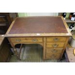 A FIRST QUARTER 20TH CENTURY OAK DESK with insert skiver top