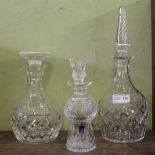 THREE DECANTERS & STOPPERS to include an Edinburgh crystal small sized 'thistle'