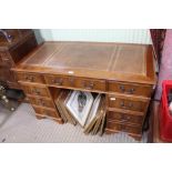 A REPRODUCTION YEW WOOD FINISHED TWIN PEDESTAL DESK