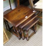 A WELL MADE REPRODUCTION OAK FINISHED NEST OF THREE TABLES