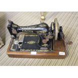 A WOODEN BASED MANUAL SINGER SEWING MACHINE