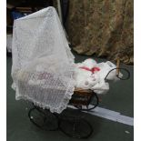A WICKER WORK PERAMBULATOR ON METAL FRAME containing a selection of soft toys