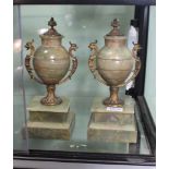 A PAIR OF METAL MOUNTED ONYX URNS