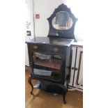 A FIRST QUARTER 20TH CENTURY PART EBONISED DISPLAY UNIT with fancy shaped mirrored back upstand, the