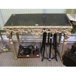 A MODERN SMOKED GLASS TOPPED CONSOLE TABLE on fancy gilded four legged base