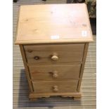 A SMALL PINE MODERN THREE DRAWER BEDSIDE CHEST