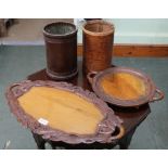 TWO CARVED PROBABLE INDIAN WOODEN TRAYS together with two waste paper baskets, one covered in